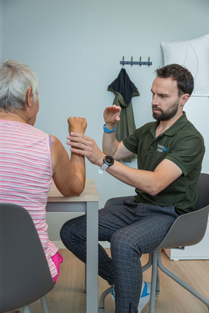 Fysio van behandelt triggerfinger van patiënt