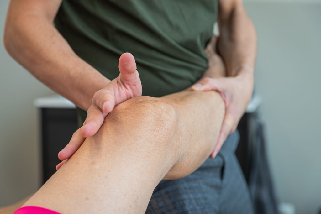 Mobilisatie oefening door de fysio voor kniepijn van patiënt